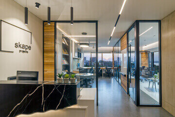 Commercial office space design with modern lighting and workstation setup